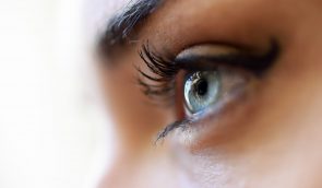 Close-up of young woman's blue eyes with long eyelashes. Make-eye